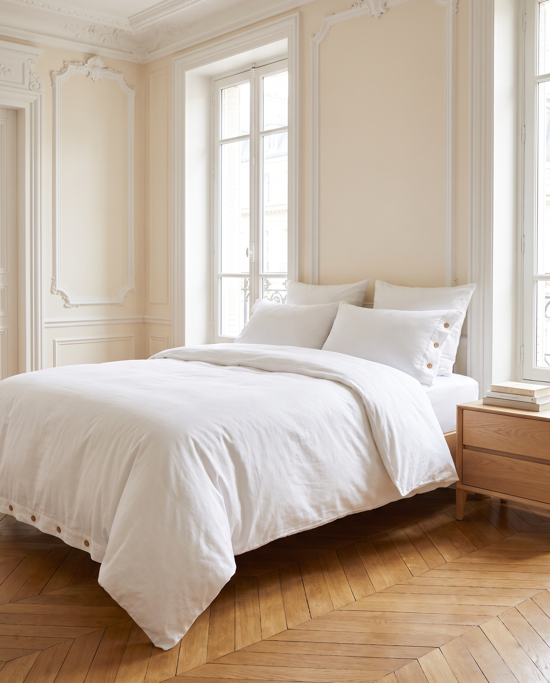 Parure de lit en percale de coton lavé blanche sur un lit, chambre haussmannienne lumineuse, Noctua Paris
