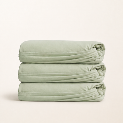 Drap-housse en coton doux vert sauge, packshot sur fond blanc chaud, Noctua Paris